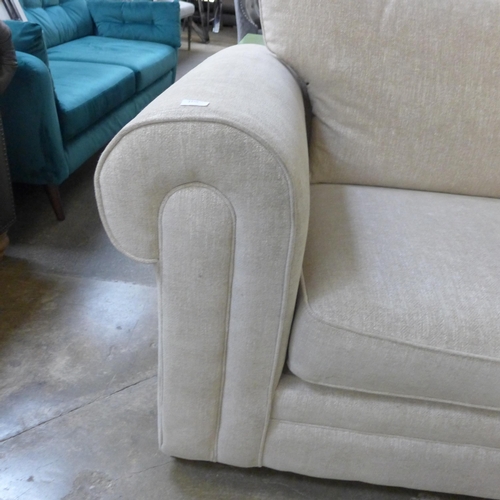 1420 - An oatmeal fleck upholstered 4 seater sofa