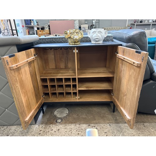 1472 - A black painted and wood two door bar cabinet with patterned front * this lot is subject to VAT