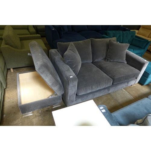 1347 - A fossil grey velvet three seater sofa and ottoman footstool