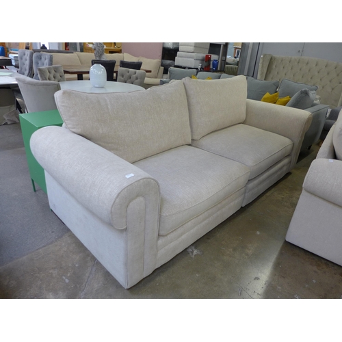 1433 - An oatmeal fleck upholstered four seater sofa