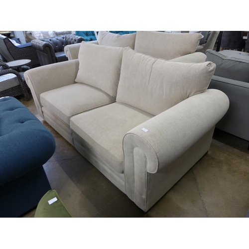 1434 - An oatmeal fleck upholstered 3.5 seater sofa