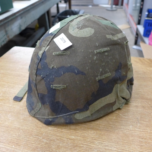 2079 - An American M1-style military helmet with removeable liner and cover