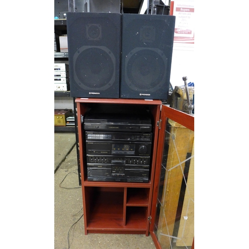 2138A - A Pioneer hi-fi system in glass fronted cabinet with speakers and remote