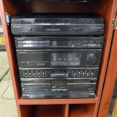 2138A - A Pioneer hi-fi system in glass fronted cabinet with speakers and remote