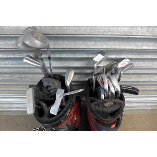 2214 - Two golf stand bags with a mixed quantity of irons/clubs