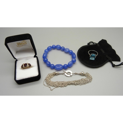 1051 - A 925 silver Links of London bracelet, a silver ring, a dress ring with blue stone and a bracelet