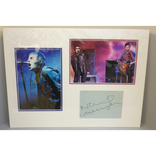 605 - An Oasis autographed display; Liam and Noel Gallagher