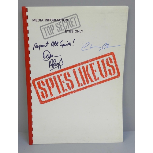 649 - A Spies Like Us film promo book autographed by Chevy Chase and Dan Aykroyd