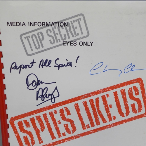 649 - A Spies Like Us film promo book autographed by Chevy Chase and Dan Aykroyd