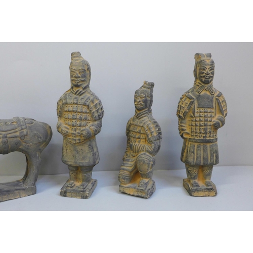 688 - Four Chinese models of terracotta warriors, horse and a resin figure of Moses