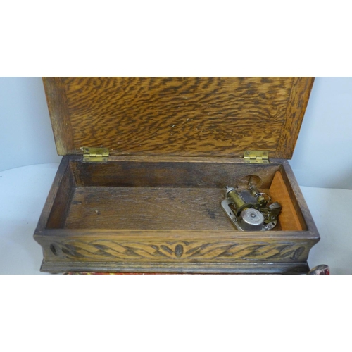 690 - An abalone decorated dressing table box, a carved wooden musical box and a crumb tray and brush