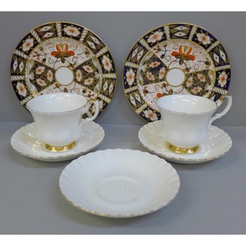 692 - Two Royal Crown Derby 2451 pattern plates and Royal Albert Val D'Or cups and saucers