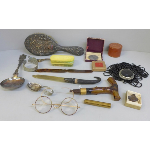 702 - Assorted items including a hair brush, spoon, bangle, letter openers, football medal, etc.