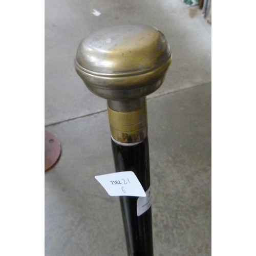 723 - Seven walking canes in cast iron stick stand