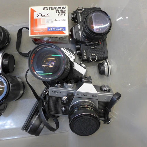 748 - Two Praktica and one Minolta 35mm SLR cameras with six spare lenses including 1:3.5-4.3 100mm