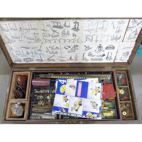 810 - A large collection of vintage Meccano in an oak case including tools, accessories, etc., double laye... 