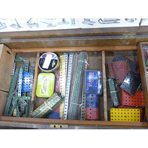 810 - A large collection of vintage Meccano in an oak case including tools, accessories, etc., double laye... 