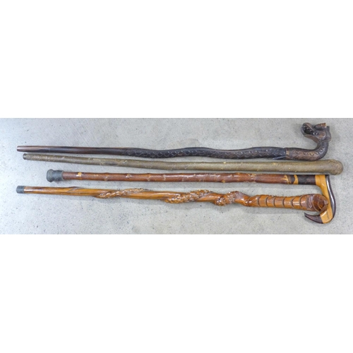 841 - Four walking canes including two carved