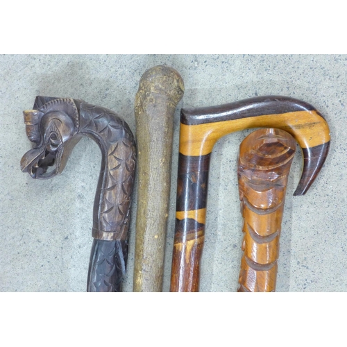 841 - Four walking canes including two carved