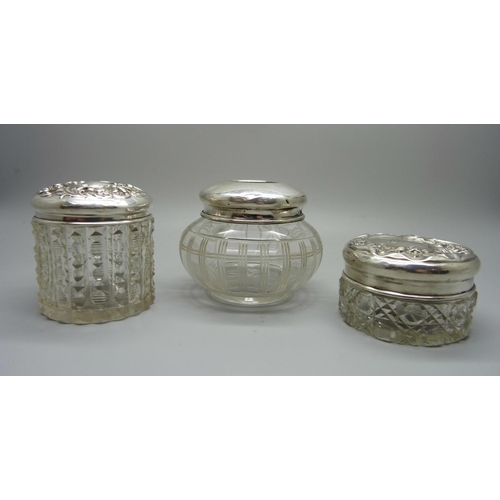 877 - Three silver topped glass jars, 29g