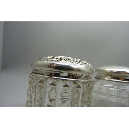 877 - Three silver topped glass jars, 29g