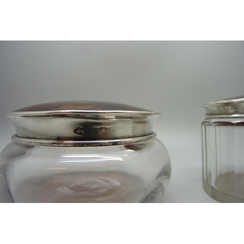 879 - Two silver and tortoiseshell topped glass jars