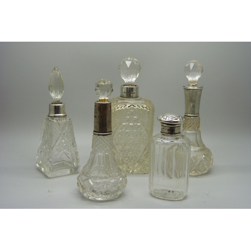 885 - Five silver mounted scent bottles