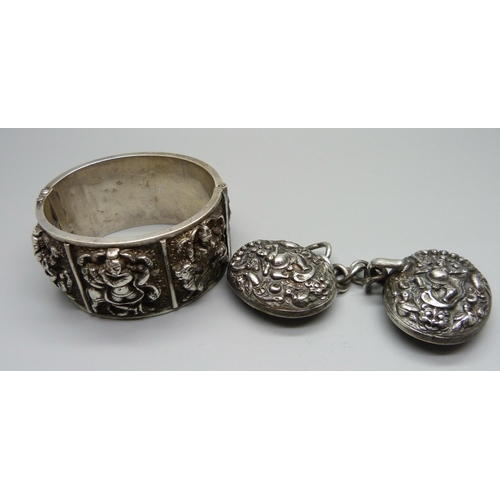 904 - An eastern white metal bangle and a cloak clasp