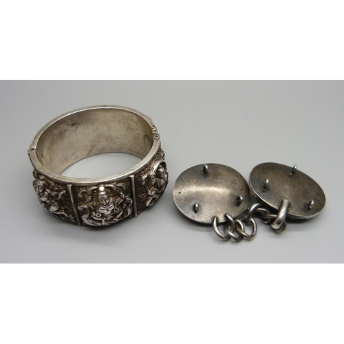 904 - An eastern white metal bangle and a cloak clasp