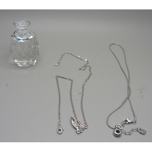 933 - A Swarovski crystal paperweight and two Swarovski crystal necklaces