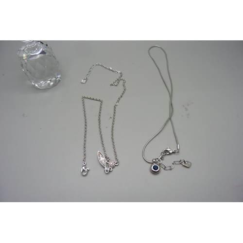 933 - A Swarovski crystal paperweight and two Swarovski crystal necklaces