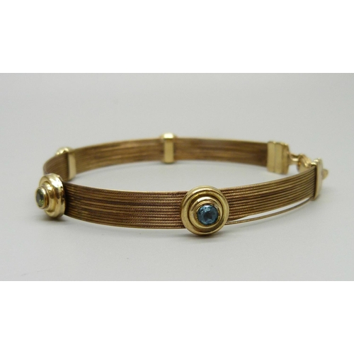 957 - A 9ct gold, topaz and peridot bracelet, 8.9g