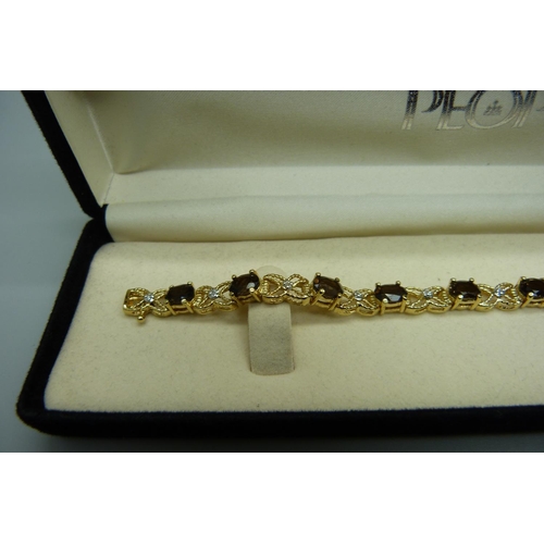 980 - A silver gilt, smoky quartz and eleven diamond bracelet