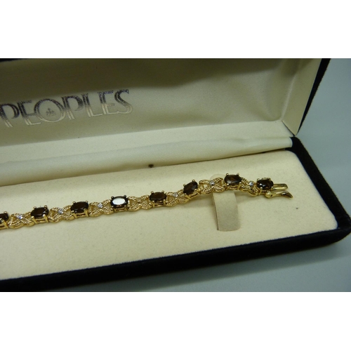 980 - A silver gilt, smoky quartz and eleven diamond bracelet