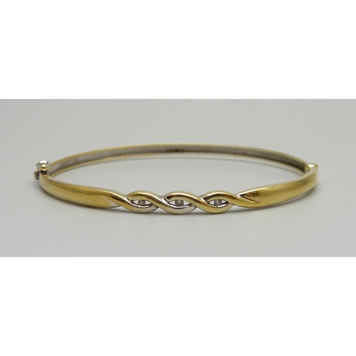 987 - A 9ct gold and diamond bangle, 8.1g