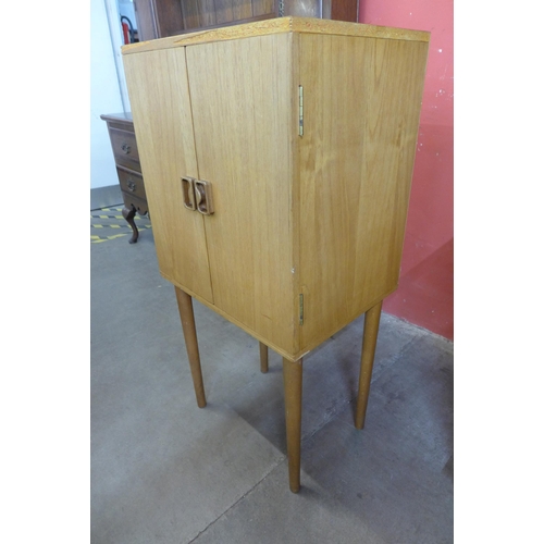 19 - A teak two door record cabinet