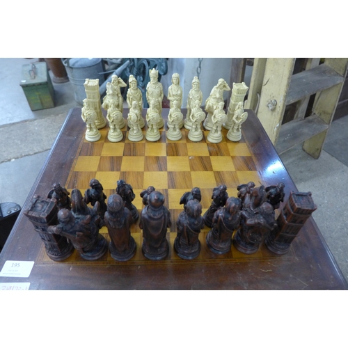 195 - A chess table and two sets of chess sets