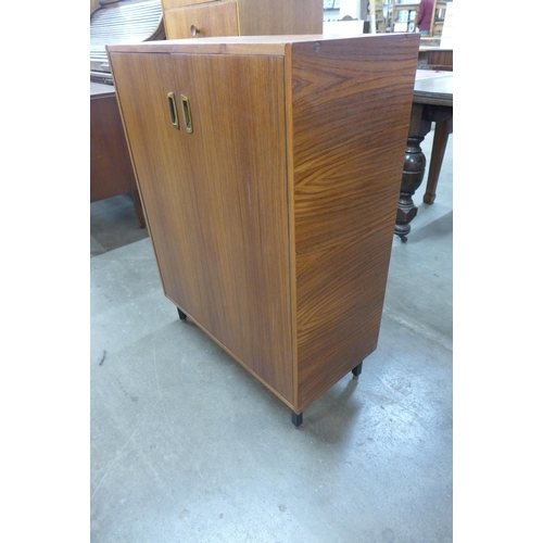 21 - A teak two door shoe cupboard