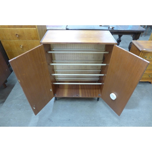 21 - A teak two door shoe cupboard