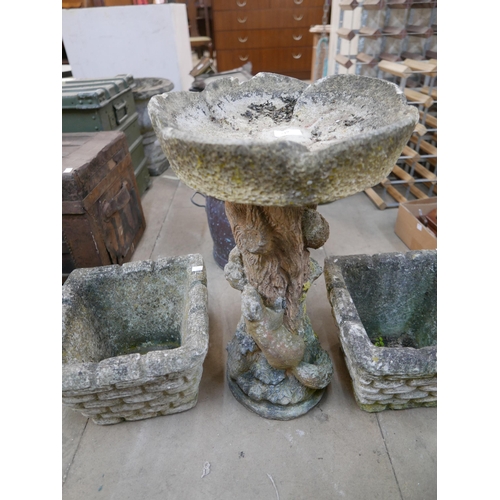 219 - A pair of concrete garden planters and a bird bath