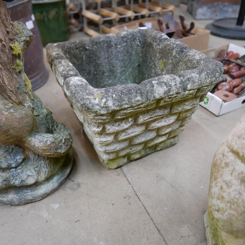 219 - A pair of concrete garden planters and a bird bath