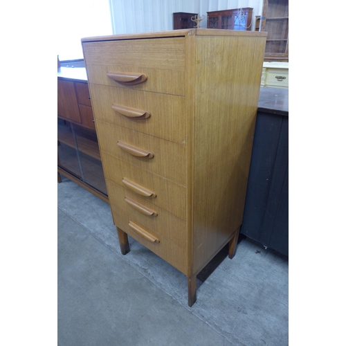 25 - A teak chest of drawers