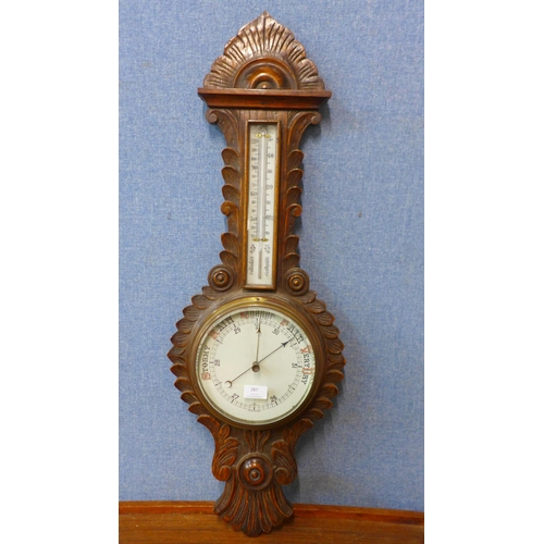 287 - An Edward VII carved oak aneroid barometer