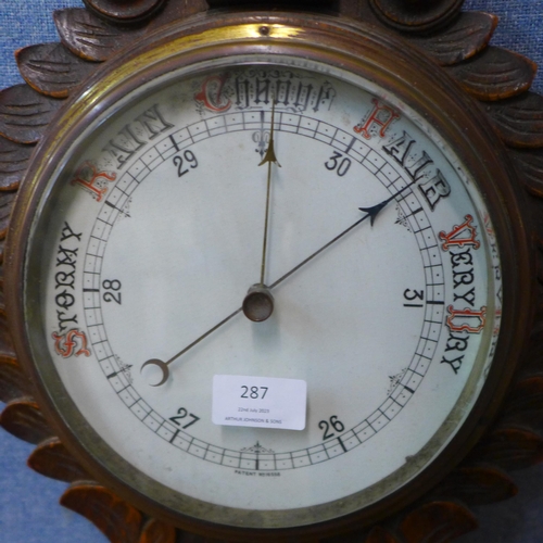 287 - An Edward VII carved oak aneroid barometer