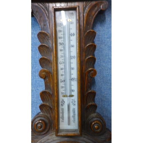 287 - An Edward VII carved oak aneroid barometer