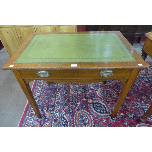 42 - An Edward VII oak and green leather topped single drawer writing table