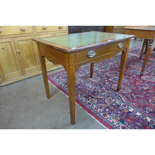 42 - An Edward VII oak and green leather topped single drawer writing table