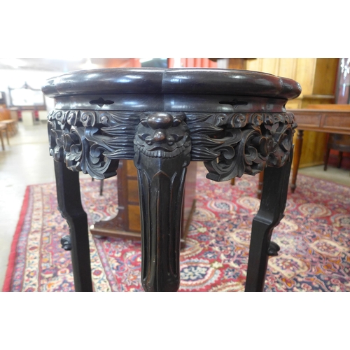 46 - A late 19th/early 20th Century Chinese carved padouk wood and marble topped jardiniere stand