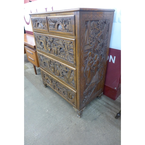 52 - An eastern carved camphorwood secretaire chest of drawers