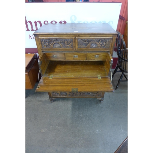 52 - An eastern carved camphorwood secretaire chest of drawers